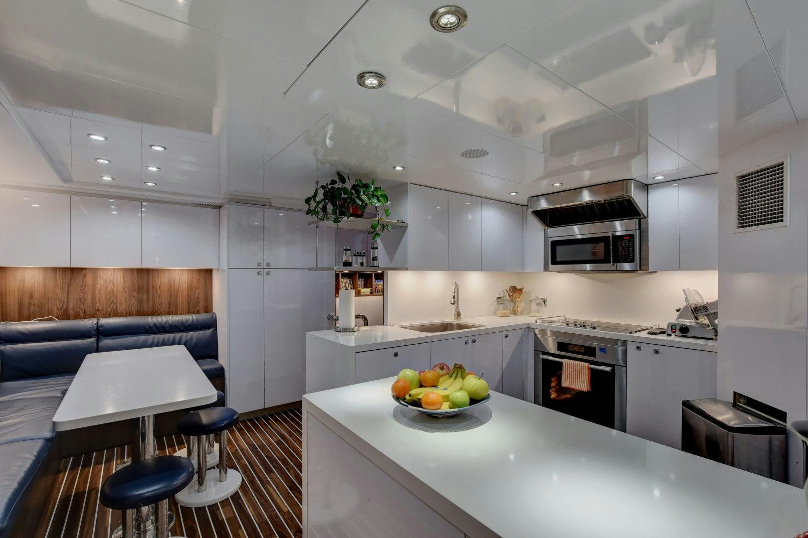 a kitchen with white cabinets aboard PARADIGM Yacht for Sale