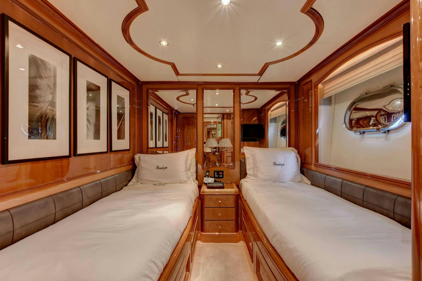 a room with a bed and a mirror aboard PARADIGM Yacht for Sale