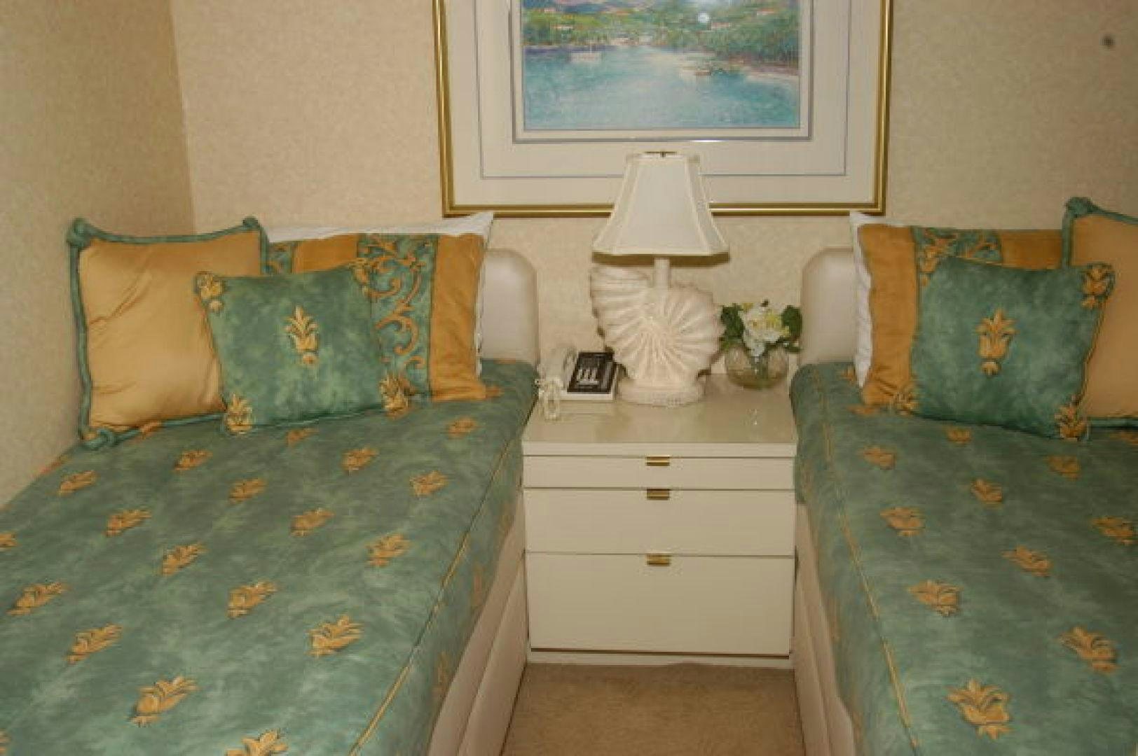 a bedroom with a bed and a lamp on the wall aboard THUNDERBALL Yacht for Sale