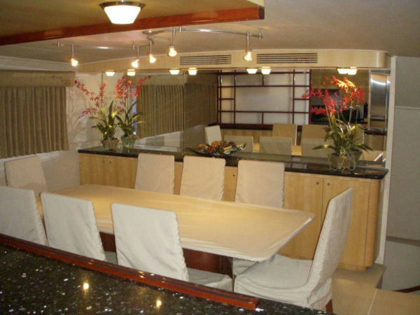 a large kitchen with a table and chairs aboard THUNDERBALL Yacht for Sale