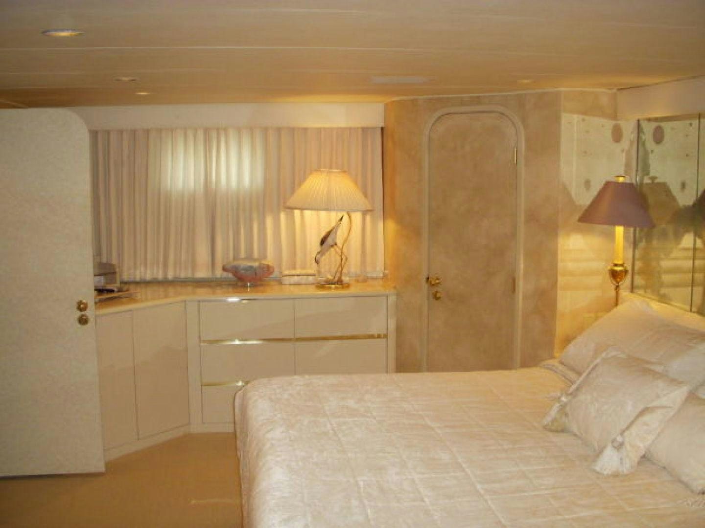 a bedroom with a bed and a desk aboard THUNDERBALL Yacht for Sale