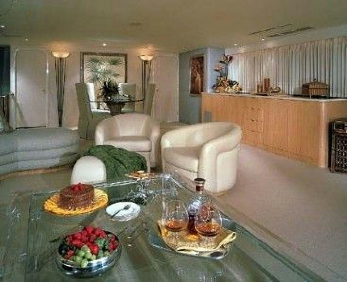 a living room with a table and chairs aboard THUNDERBALL Yacht for Sale