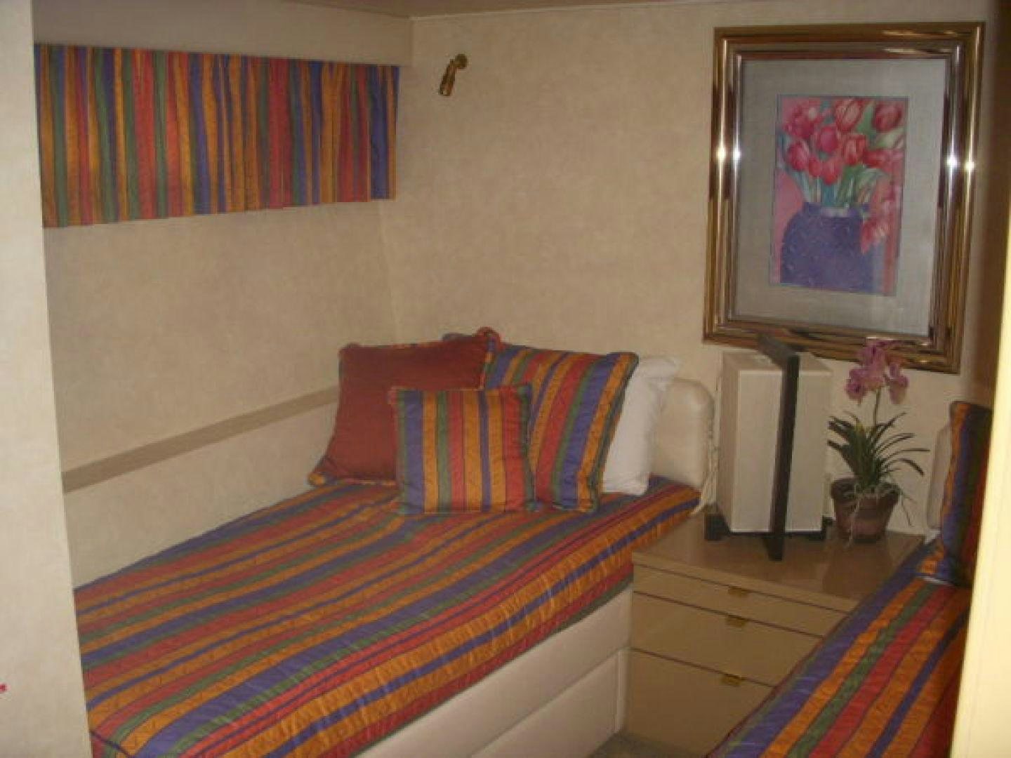 a bed with a colorful blanket aboard THUNDERBALL Yacht for Sale