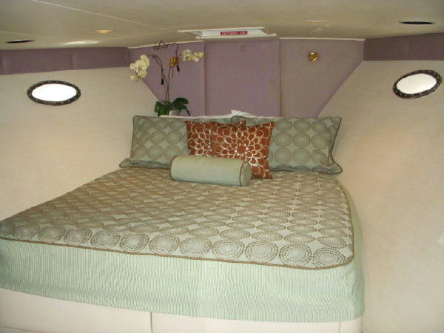 a bed with a flowered pillow aboard THUNDERBALL Yacht for Sale