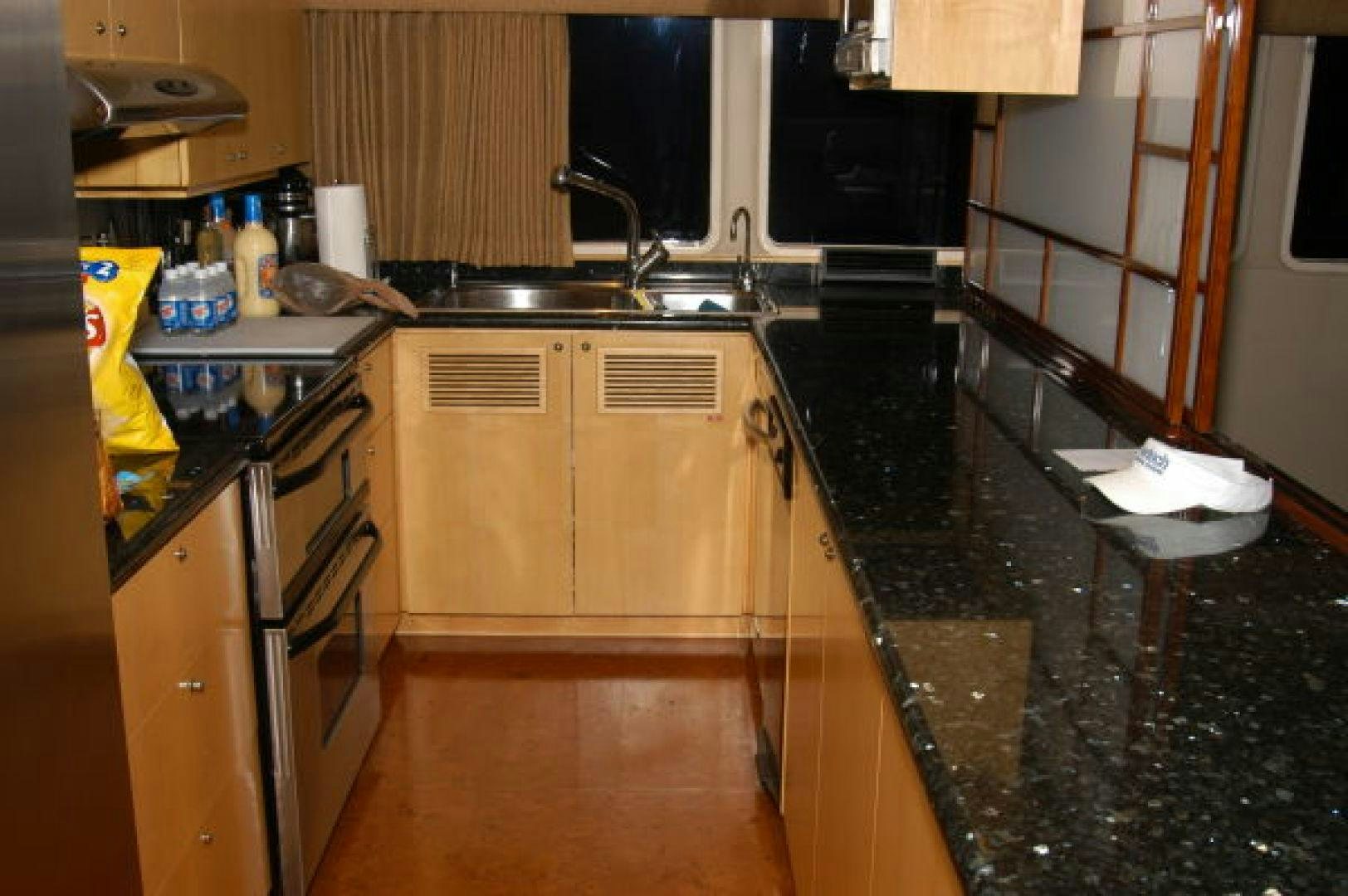 a kitchen with a sink and a stove aboard THUNDERBALL Yacht for Sale