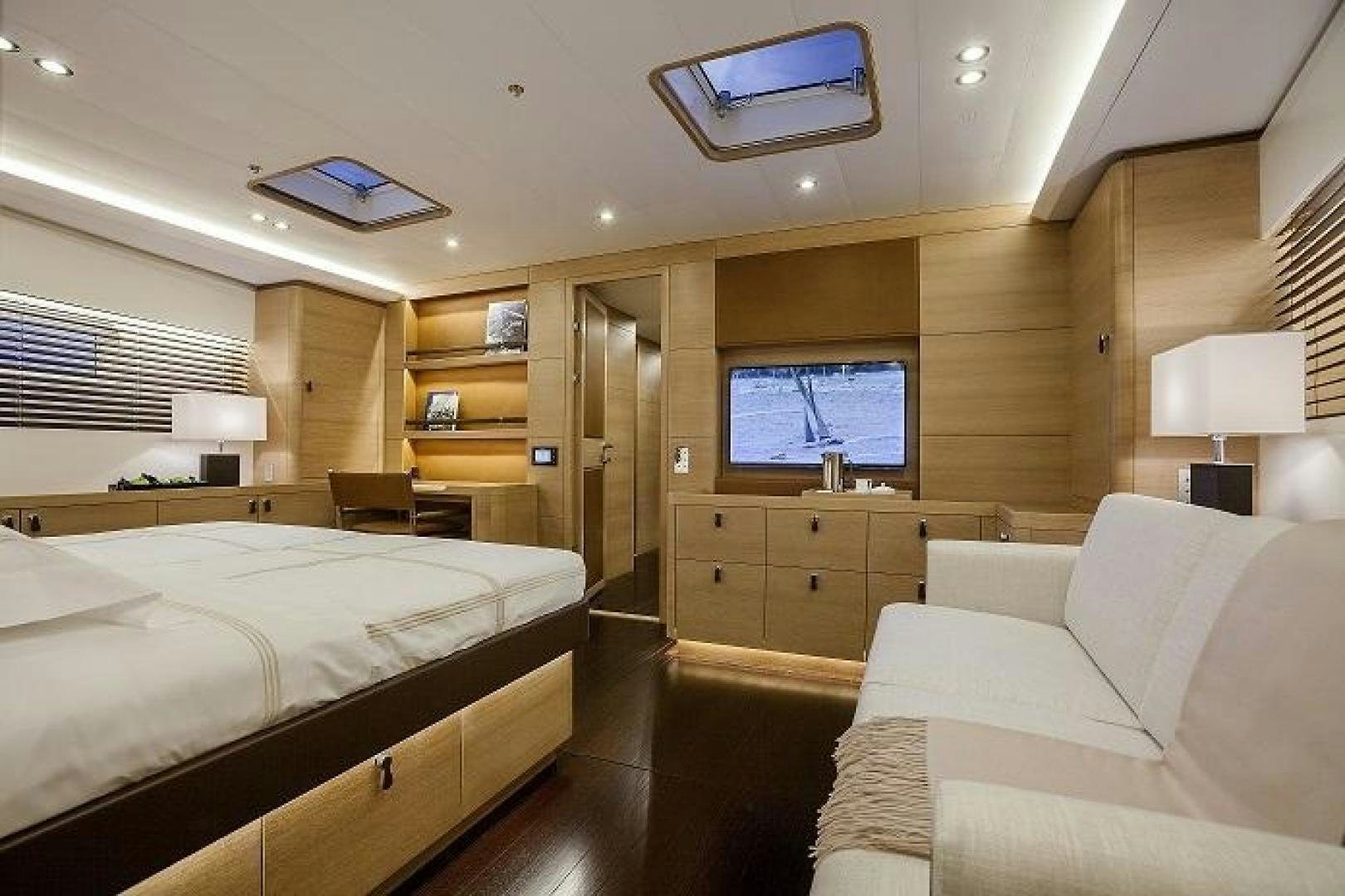 a bedroom with a bed and a tv aboard DARLIN Yacht for Charter