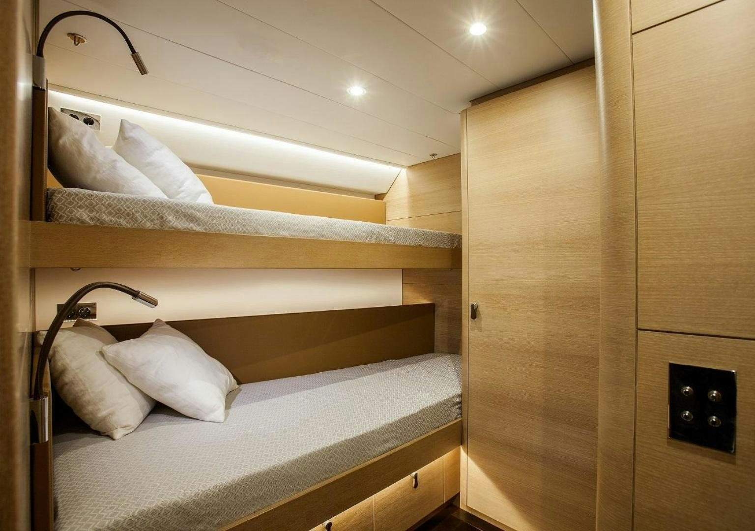 a bed with white sheets aboard DARLIN Yacht for Charter