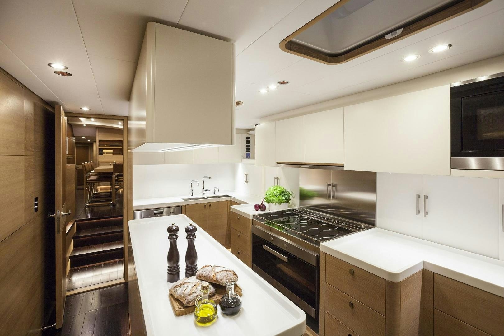 a kitchen with white cabinets aboard DARLIN Yacht for Charter
