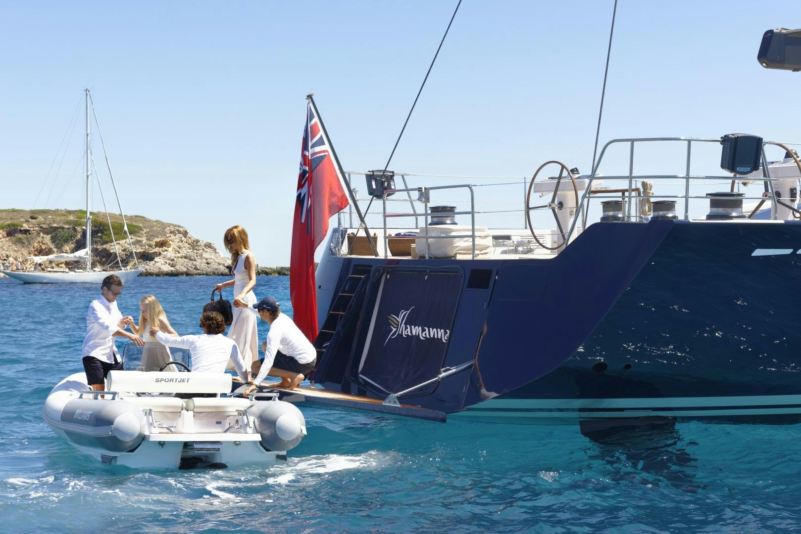a boat with a flag on it aboard DARLIN Yacht for Charter