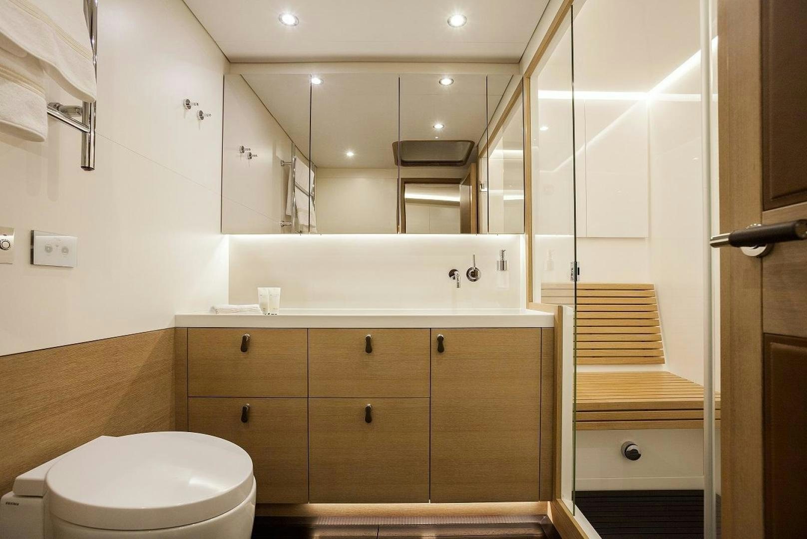a bathroom with a toilet and a mirror aboard DARLIN Yacht for Charter