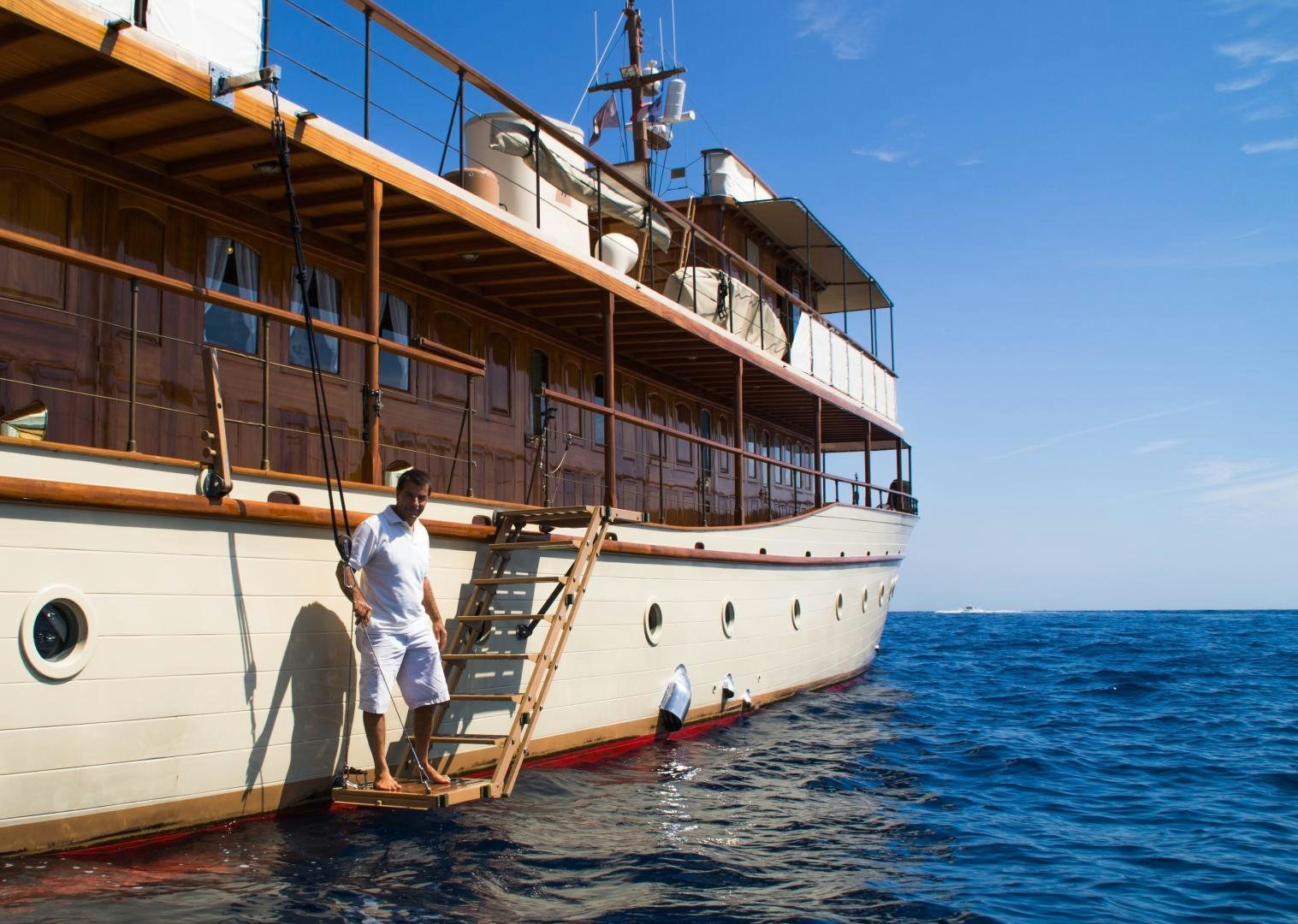 a person sitting on a boat aboard OVER THE RAINBOW OF LONDON Yacht for Sale