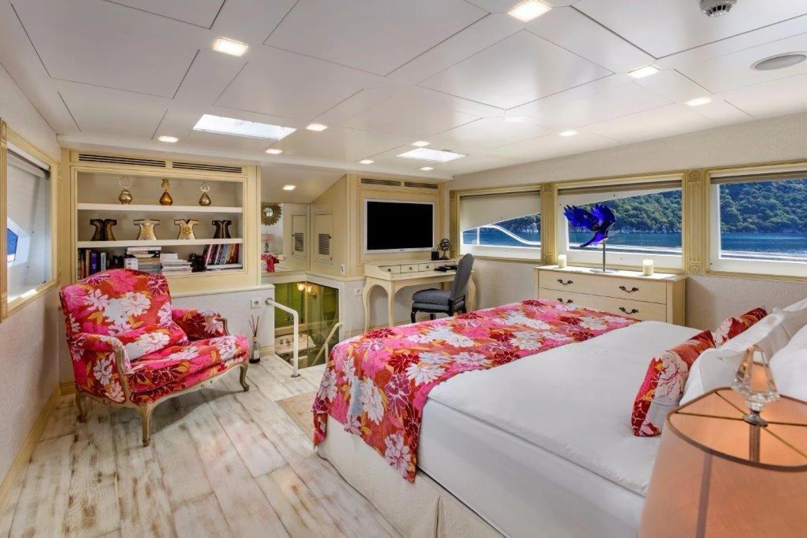 a room with a bed and a chair aboard M&M Yacht for Sale