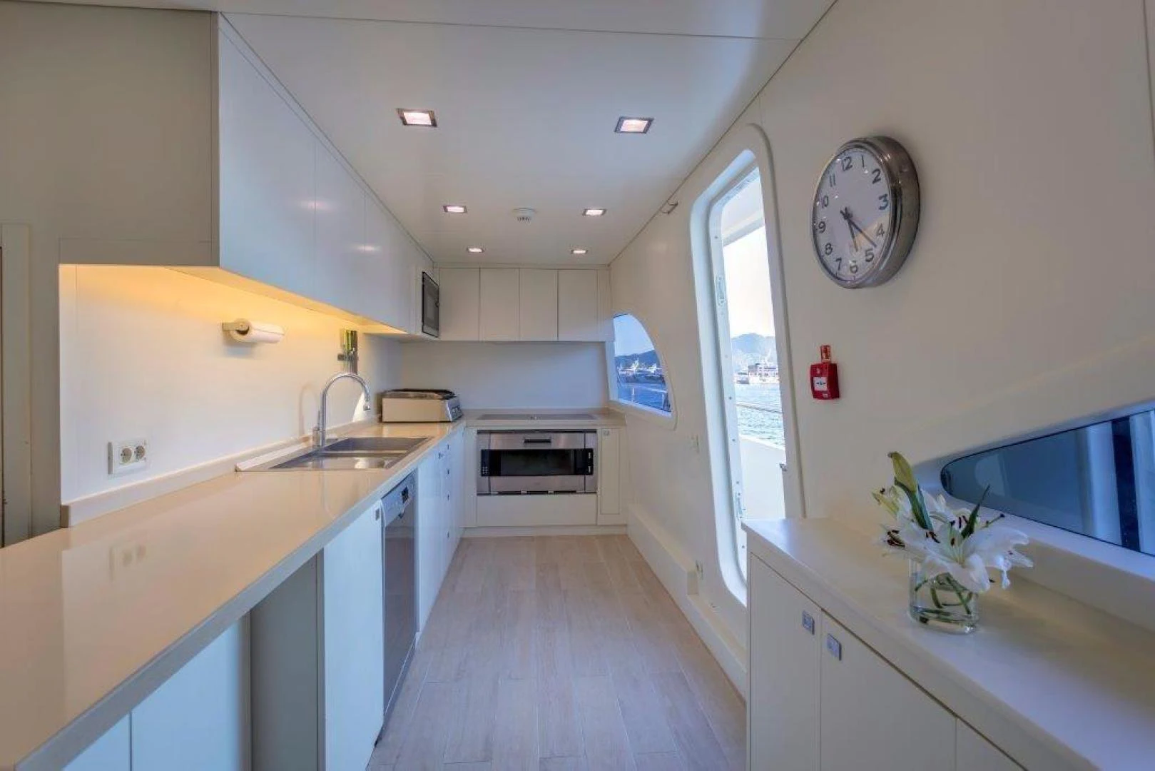 a kitchen with a large clock aboard M&M Yacht for Sale