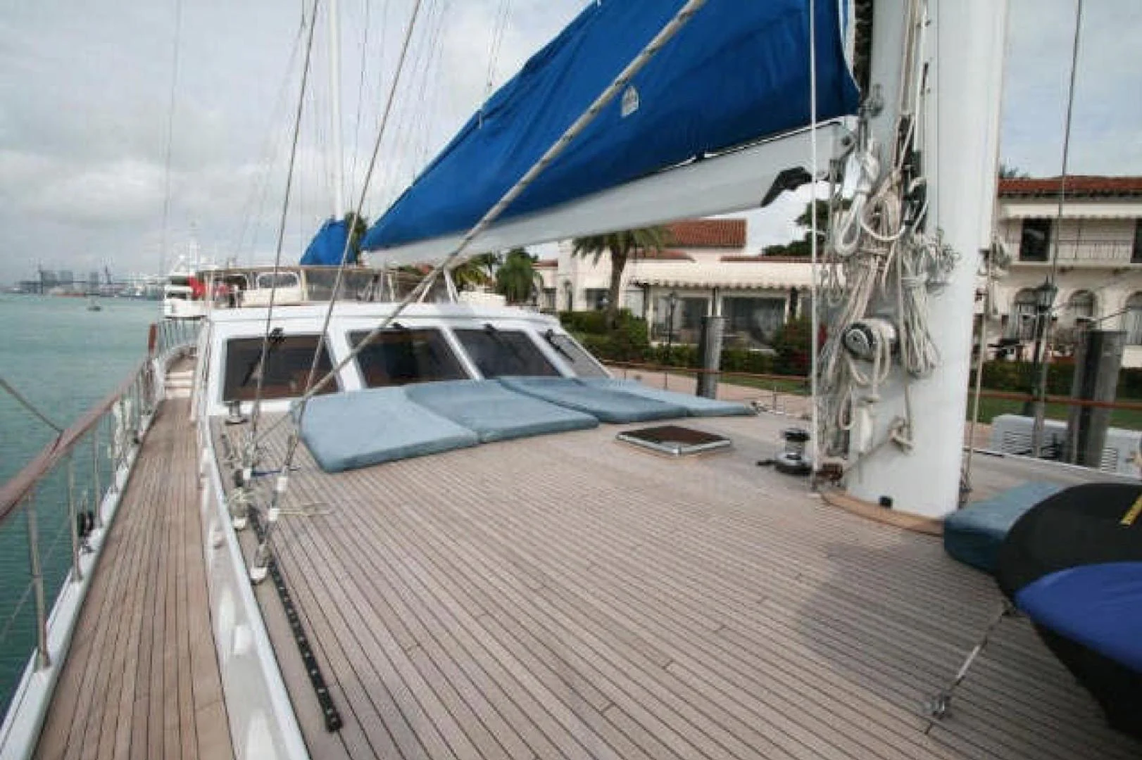 a deck with a boat and a sailboat on it aboard QUEEN SOUTH III Yacht for Sale