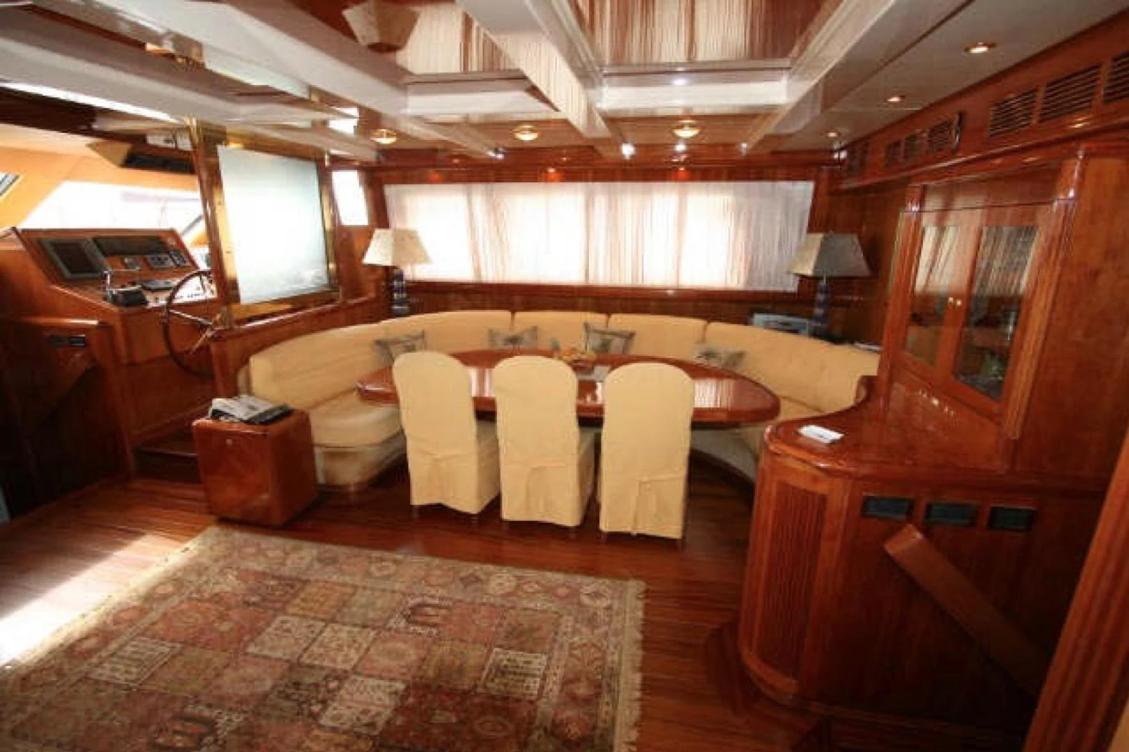 a large room with a table and chairs aboard QUEEN SOUTH III Yacht for Sale