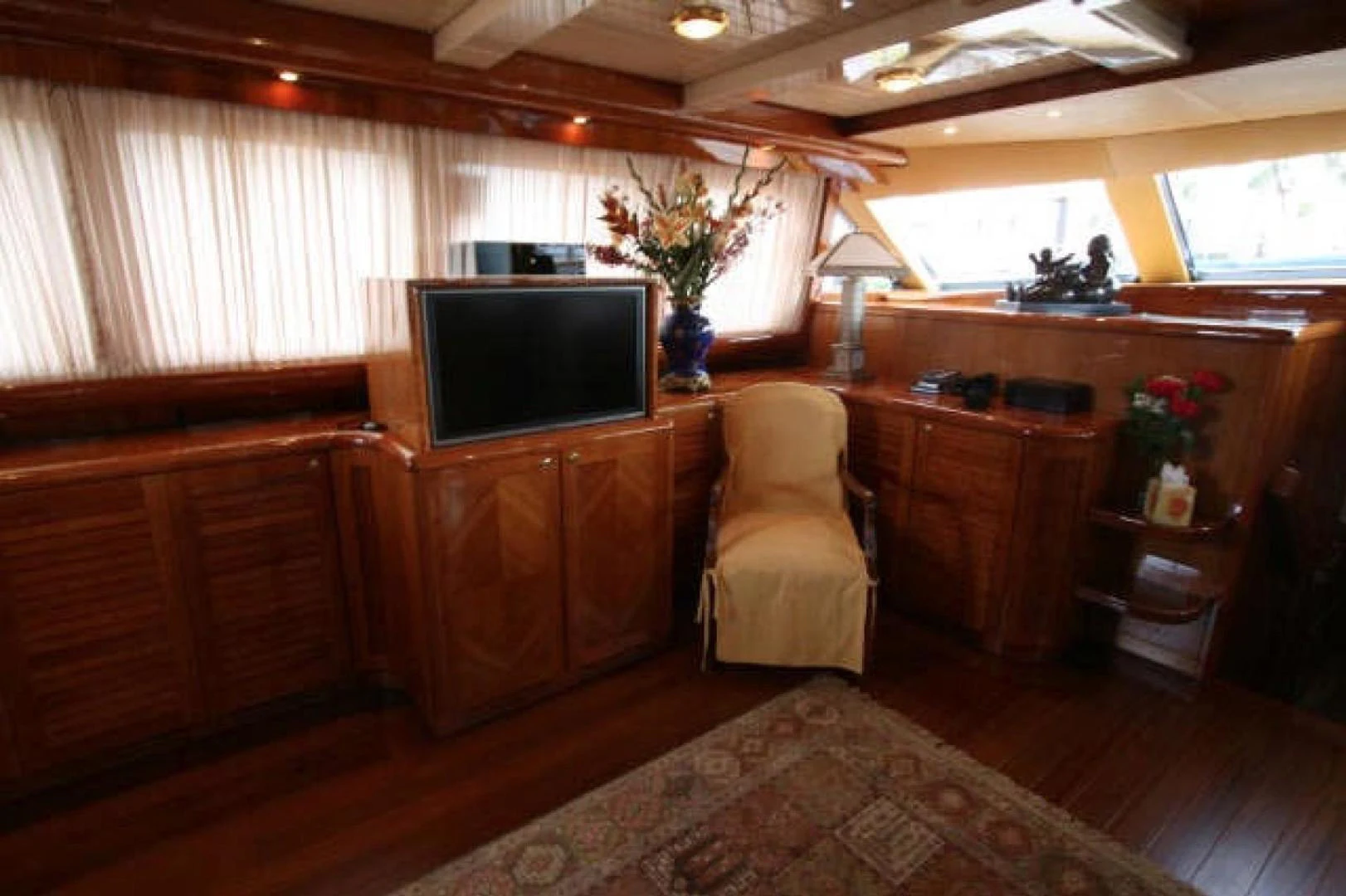 a room with a tv and a chair aboard QUEEN SOUTH III Yacht for Sale