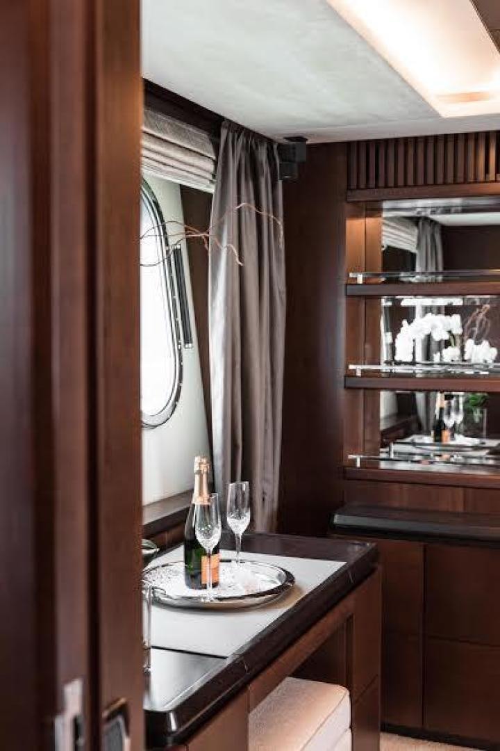 a wine bottle and a plate on a table aboard TAIL LIGHTS Yacht for Sale