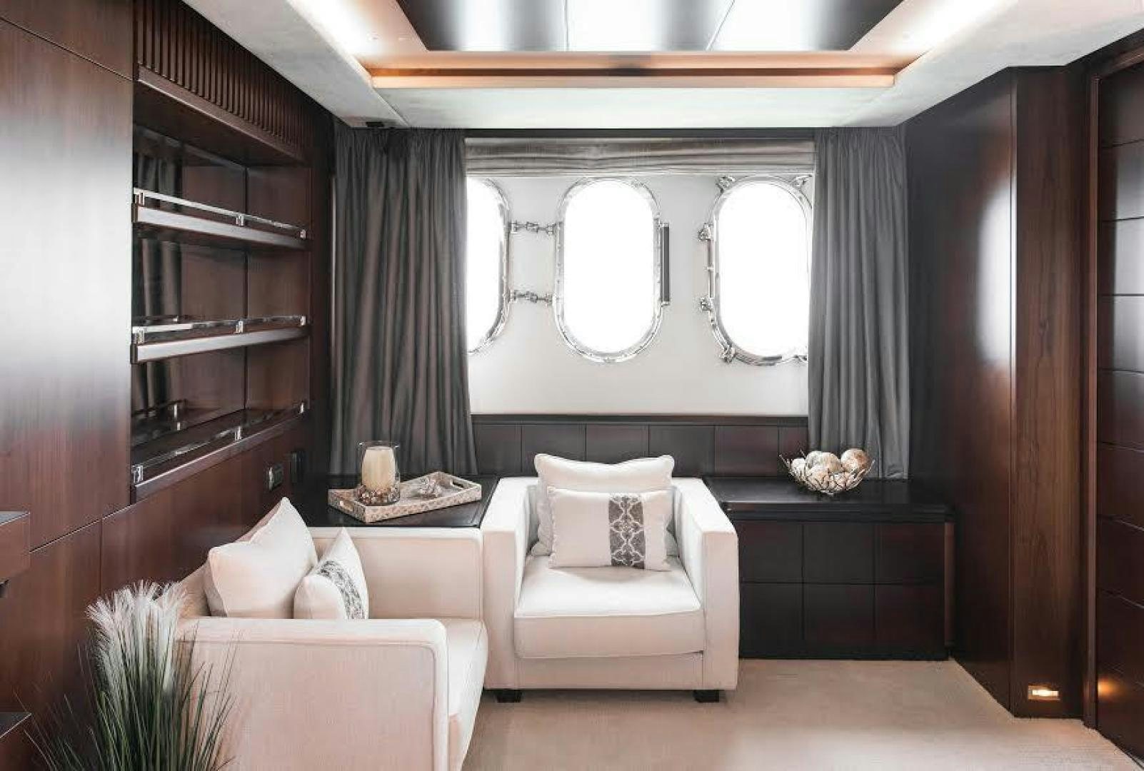 a room with a mirror and couches aboard TAIL LIGHTS Yacht for Sale