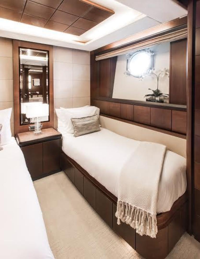 a room with a bed and a mirror aboard TAIL LIGHTS Yacht for Sale