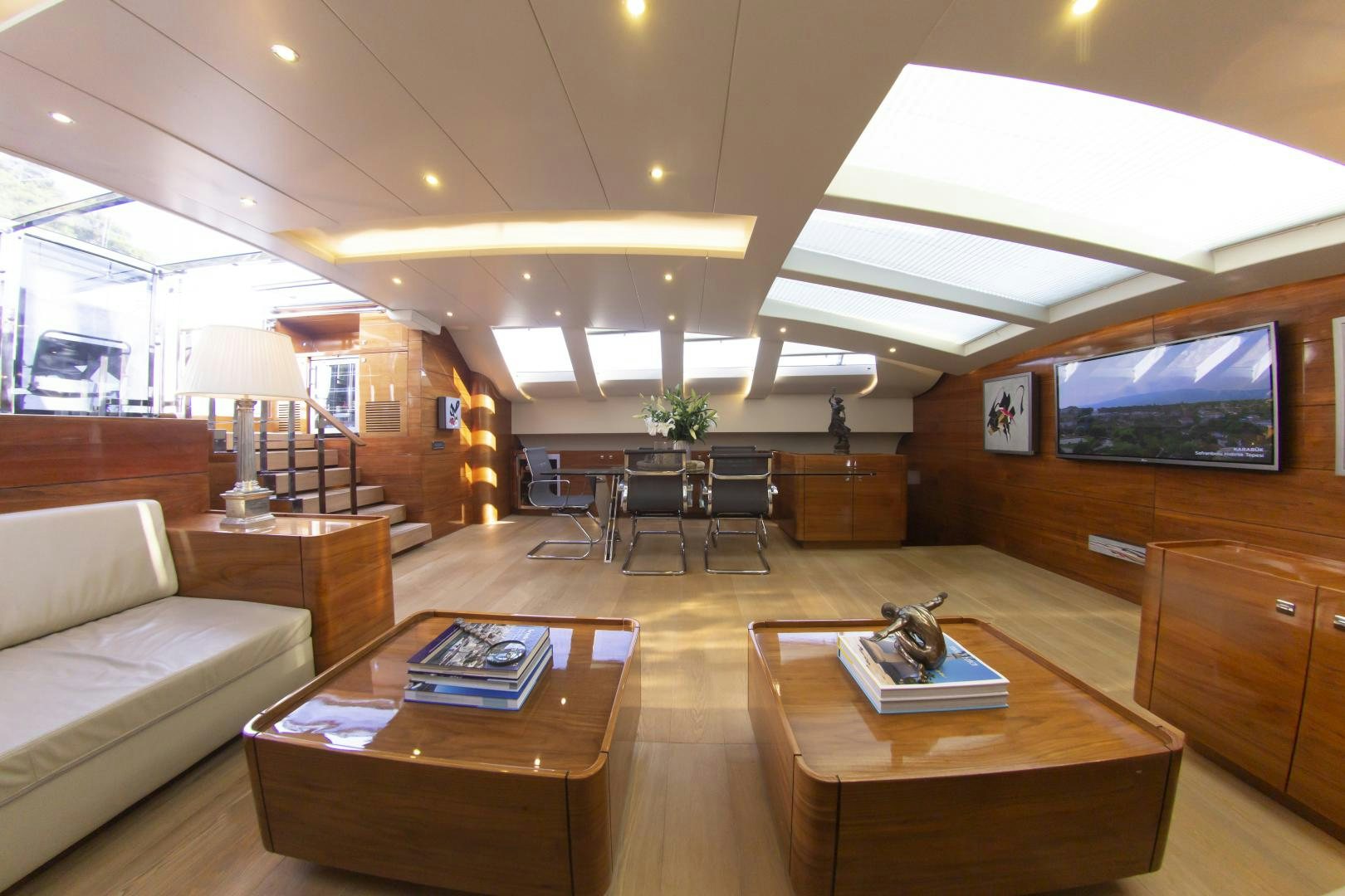 a living room with a large television aboard MUSIC Yacht for Sale