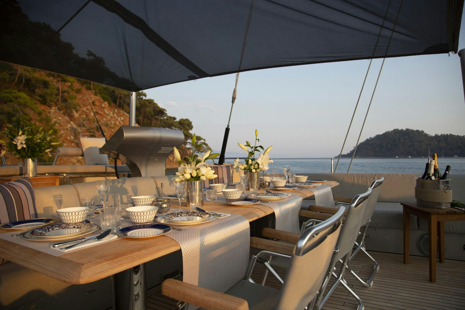 a table with plates and glasses on it aboard MUSIC Yacht for Sale
