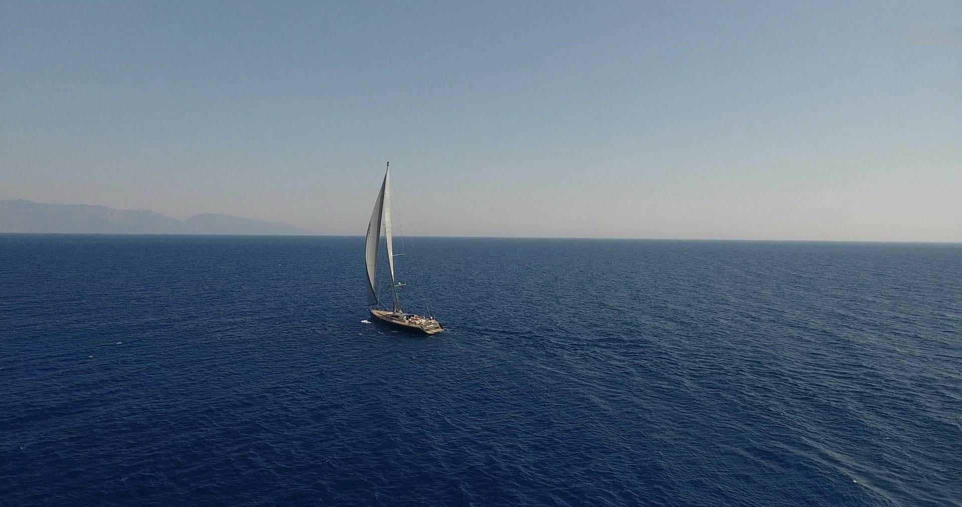a sailboat in the middle of the ocean aboard MUSIC Yacht for Sale