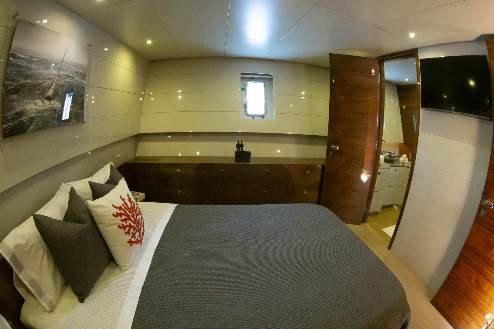 a room with a bed and a wood door aboard MUSIC Yacht for Charter