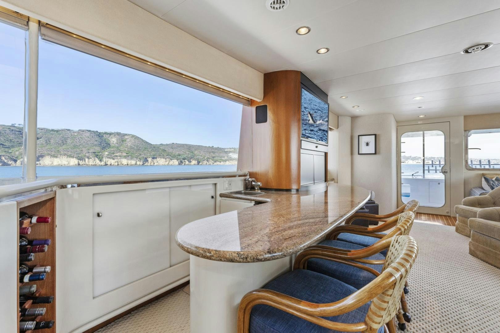 a living room with a large window aboard AQUILA Yacht for Sale