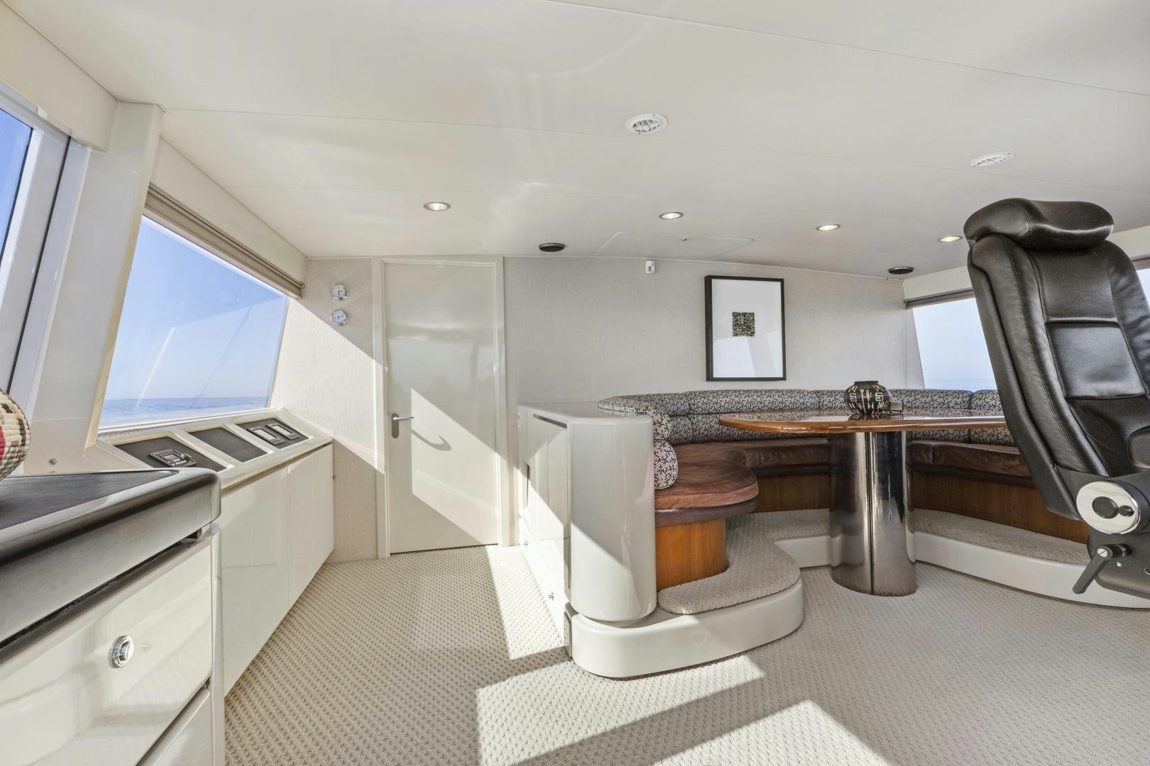 a large room with a table and chairs aboard AQUILA Yacht for Sale