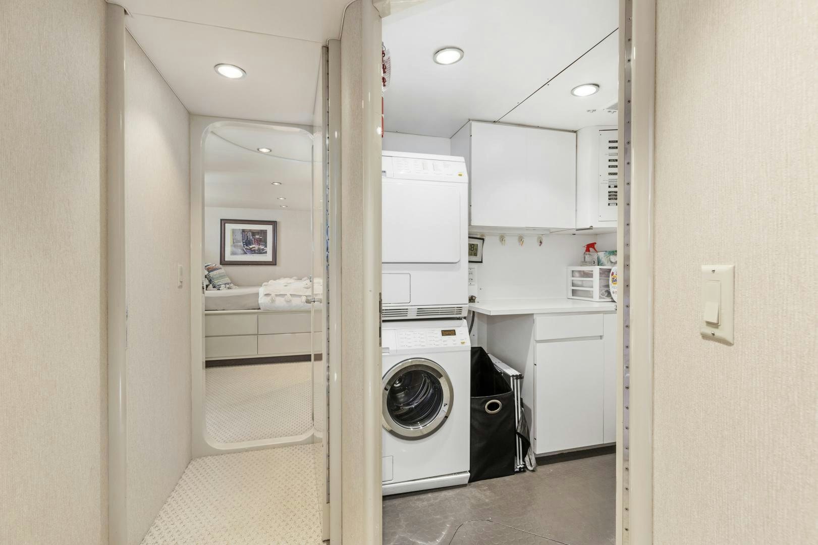 a room with a washing machine and dryer aboard AQUILA Yacht for Sale