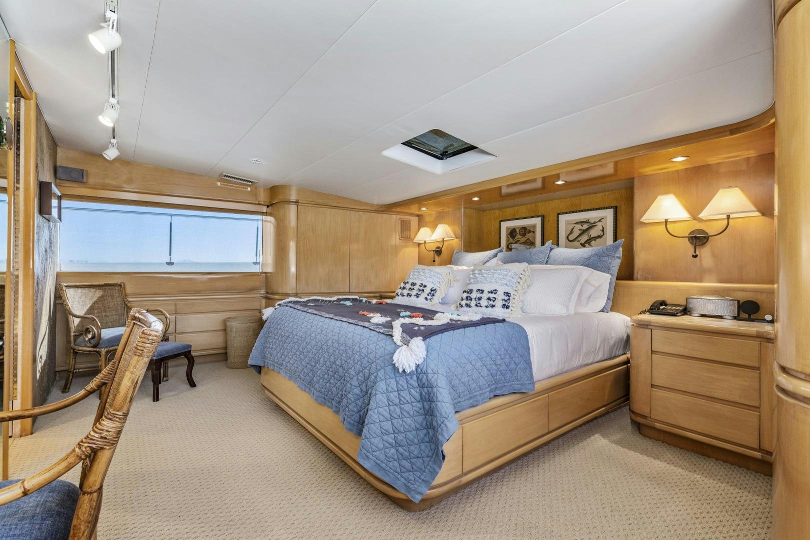 a bedroom with a bed and a television on the wall aboard AQUILA Yacht for Sale
