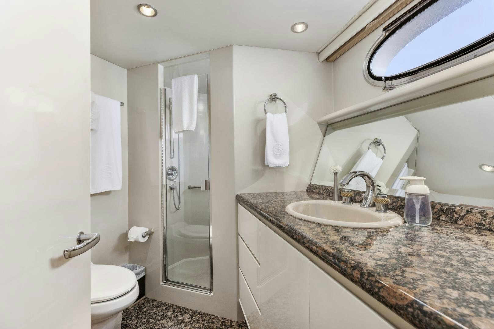 a bathroom with a marble countertop aboard AQUILA Yacht for Sale
