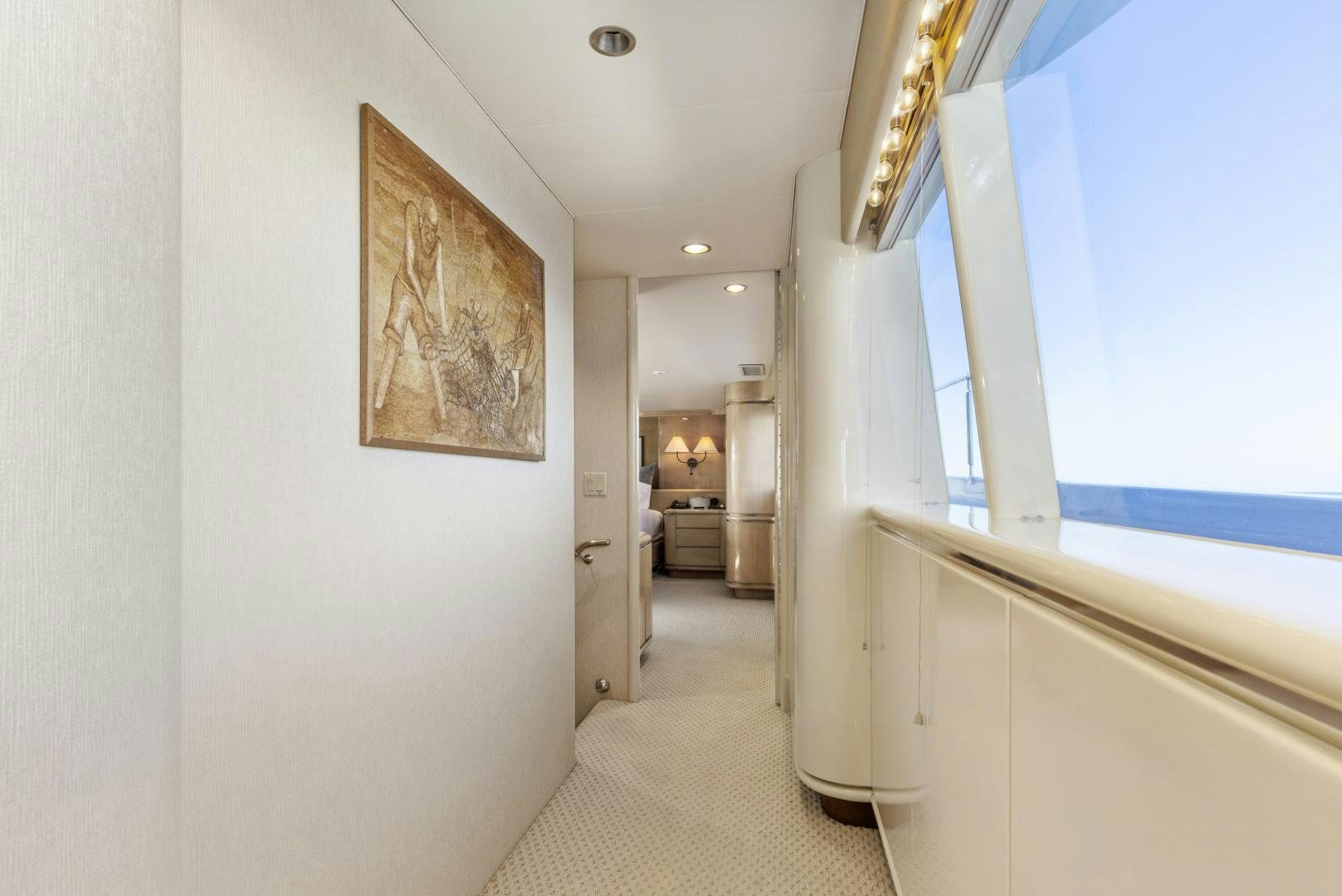 a hallway with a painting on the wall aboard AQUILA Yacht for Sale