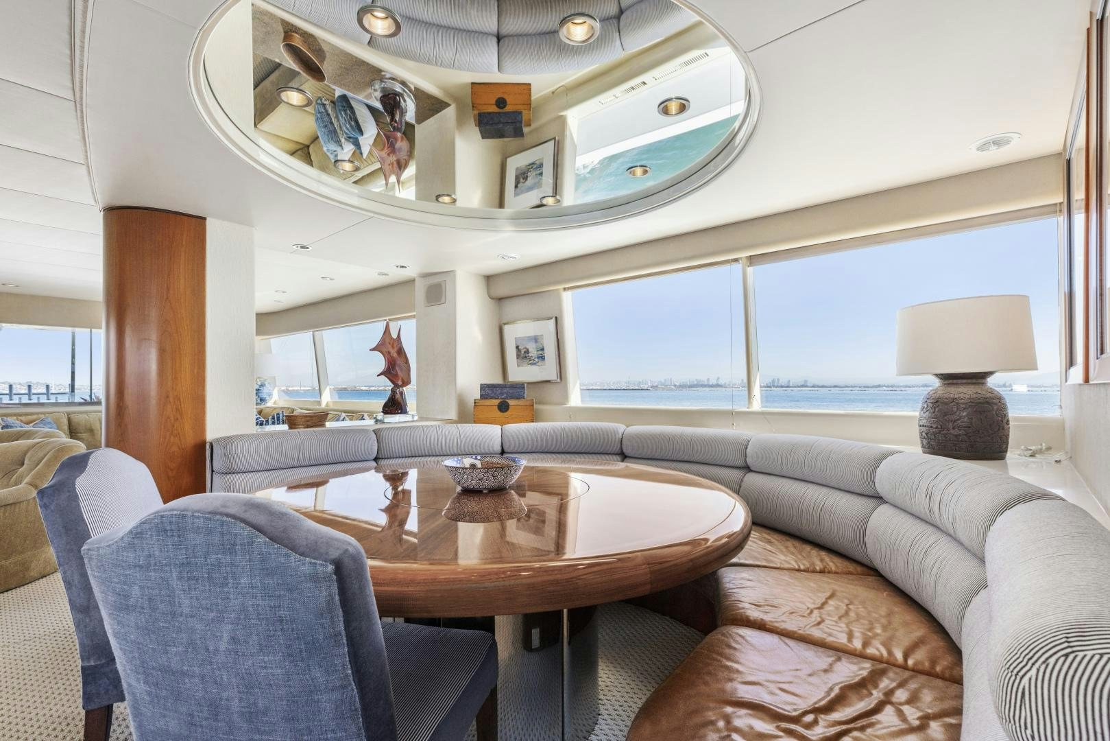 a living room with a table and chairs aboard AQUILA Yacht for Sale