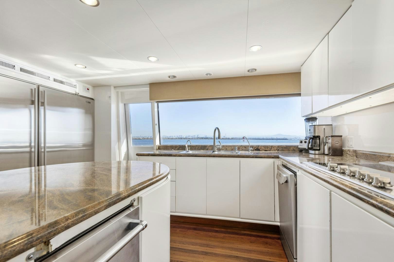 a kitchen with white cabinets aboard AQUILA Yacht for Sale