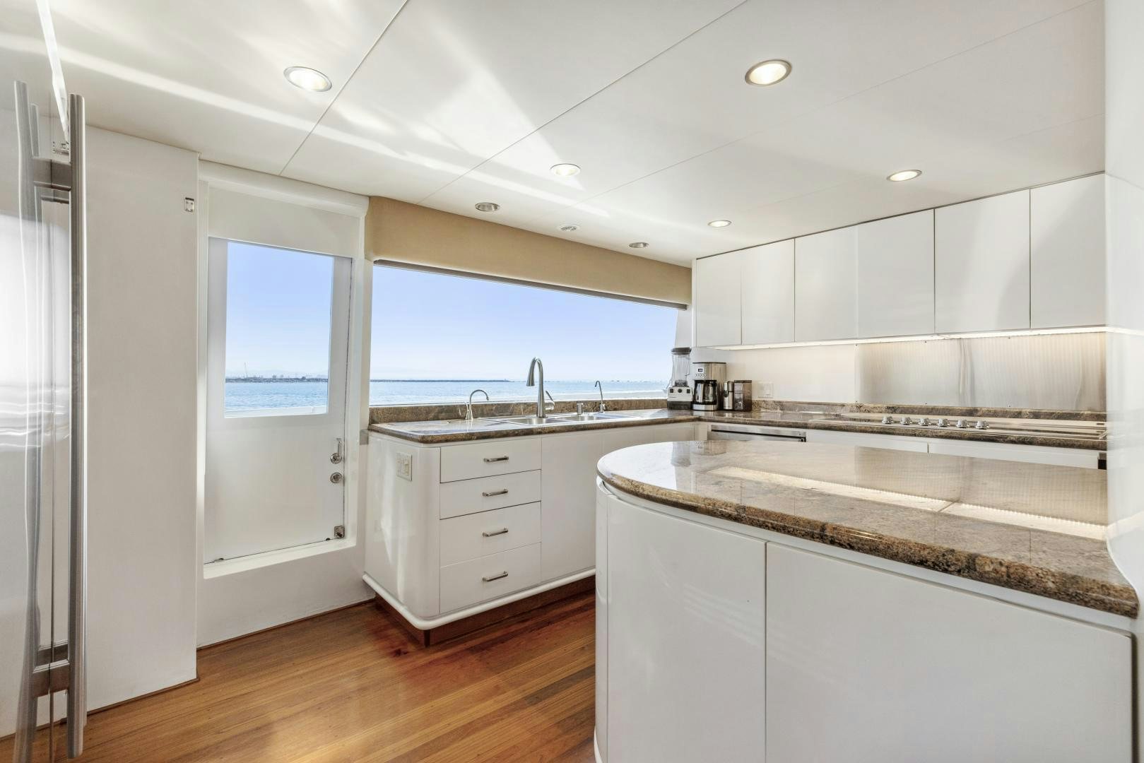 a kitchen with white cabinets aboard AQUILA Yacht for Sale