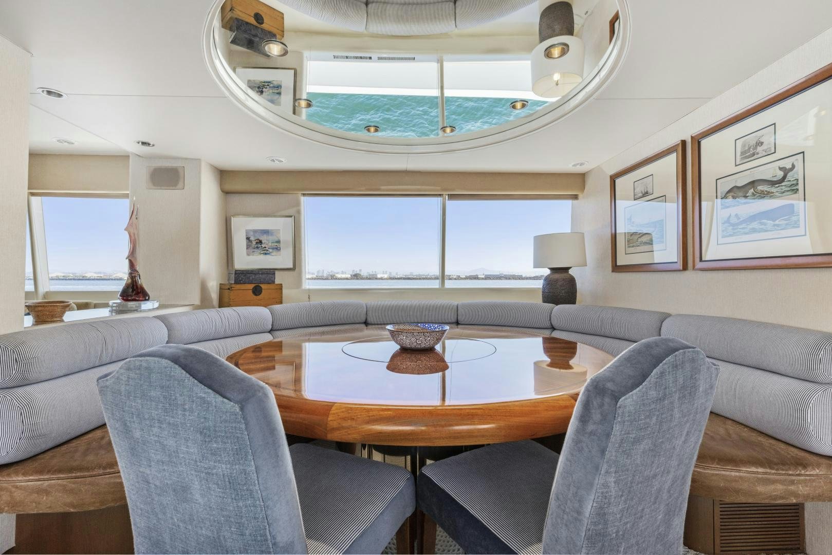 a living room with a table and chairs aboard AQUILA Yacht for Sale