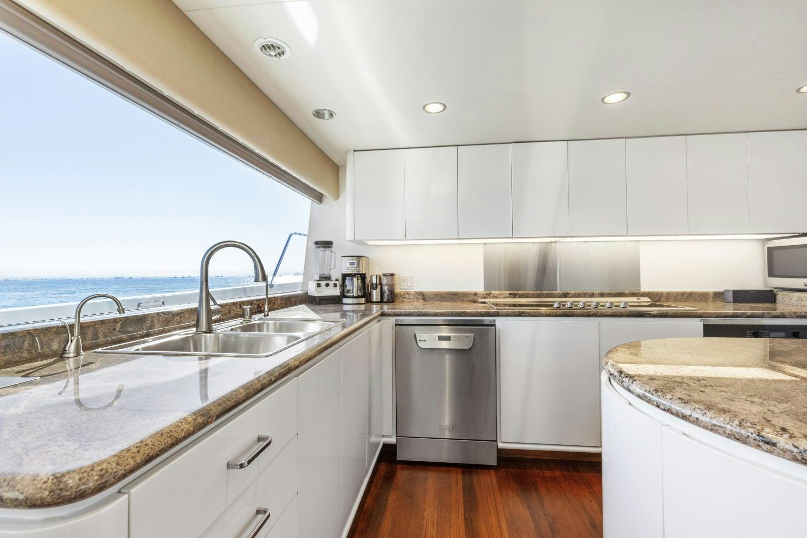 a kitchen with white cabinets aboard AQUILA Yacht for Sale