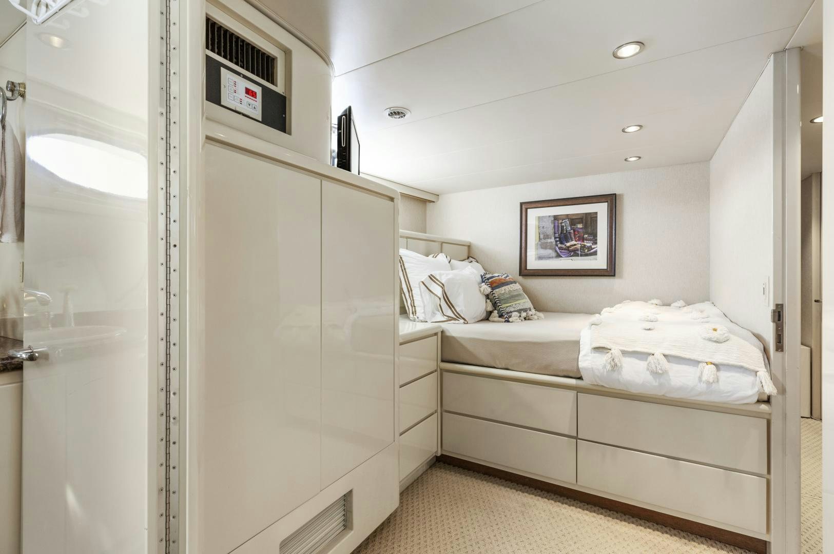 a room with a bed and a closet aboard AQUILA Yacht for Sale