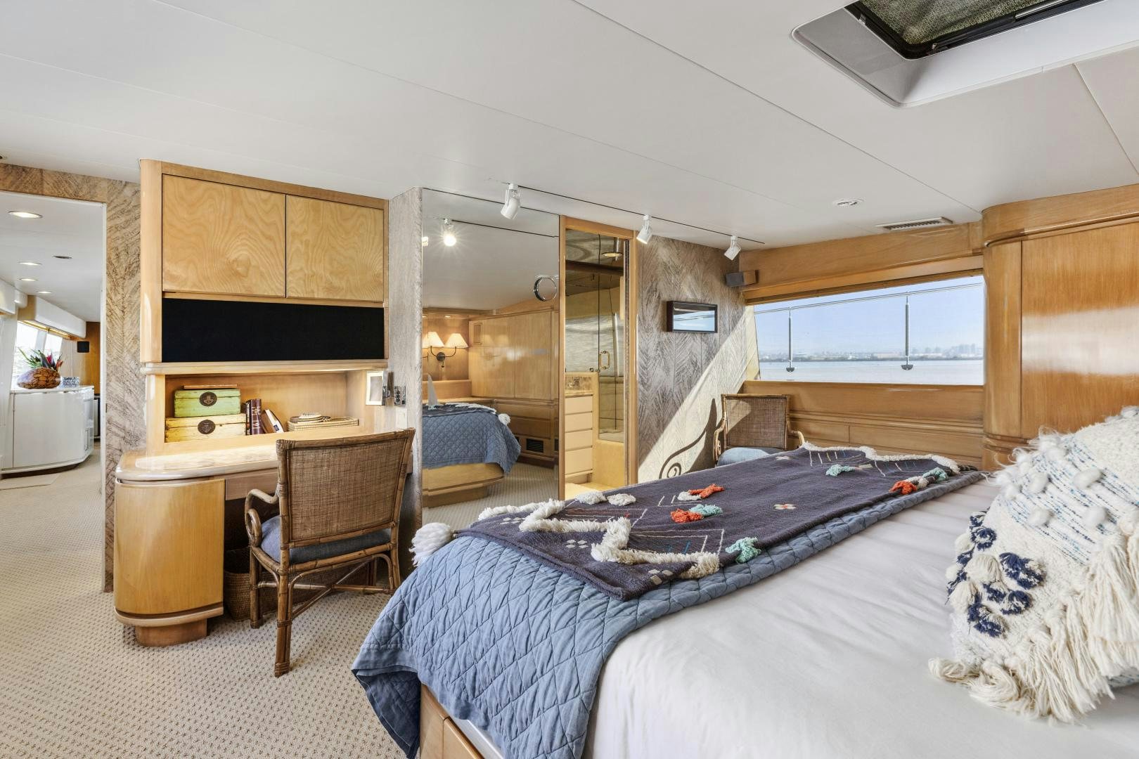 a bedroom with a bed and desk aboard AQUILA Yacht for Sale