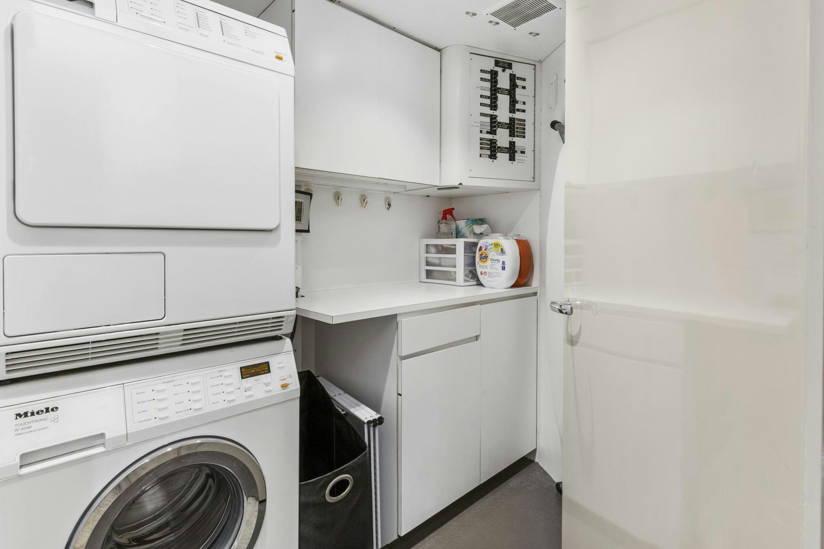 a white kitchen with white cabinets aboard AQUILA Yacht for Sale