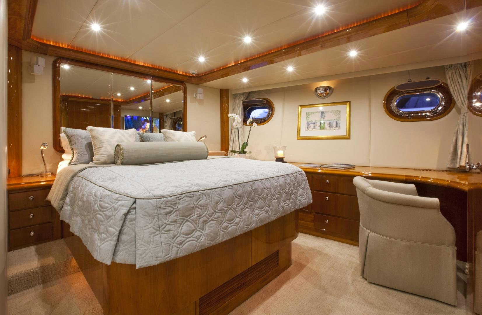 a large bedroom with a large mirror aboard REE Yacht for Sale