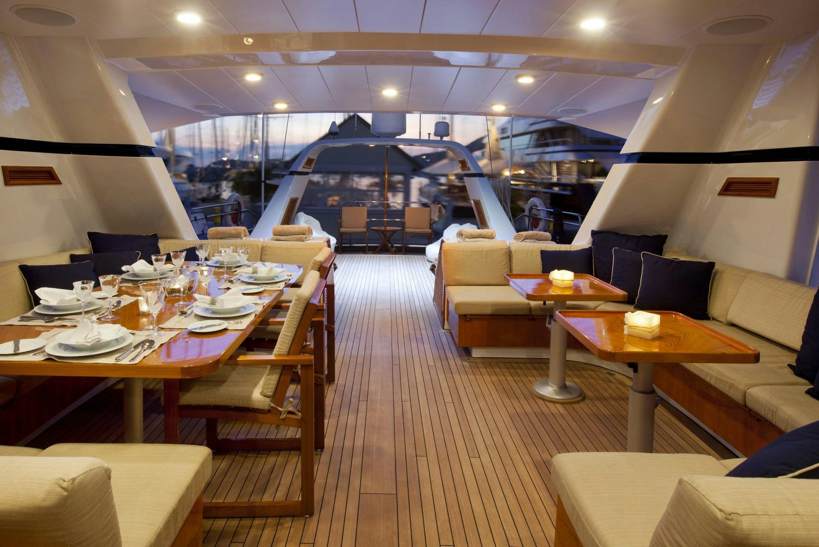 a restaurant with tables and chairs aboard REE Yacht for Sale
