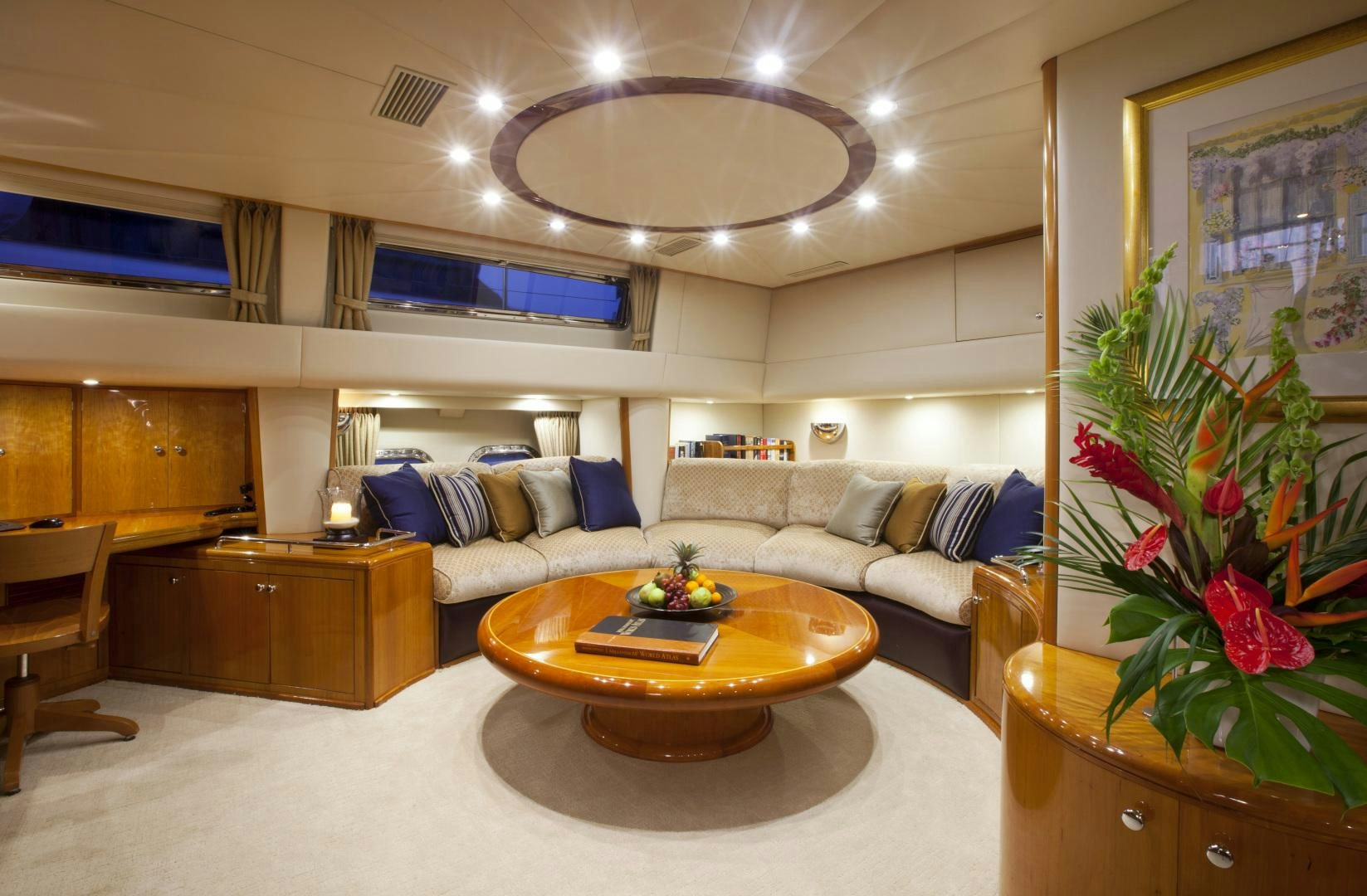 a living room with a large chandelier aboard REE Yacht for Sale