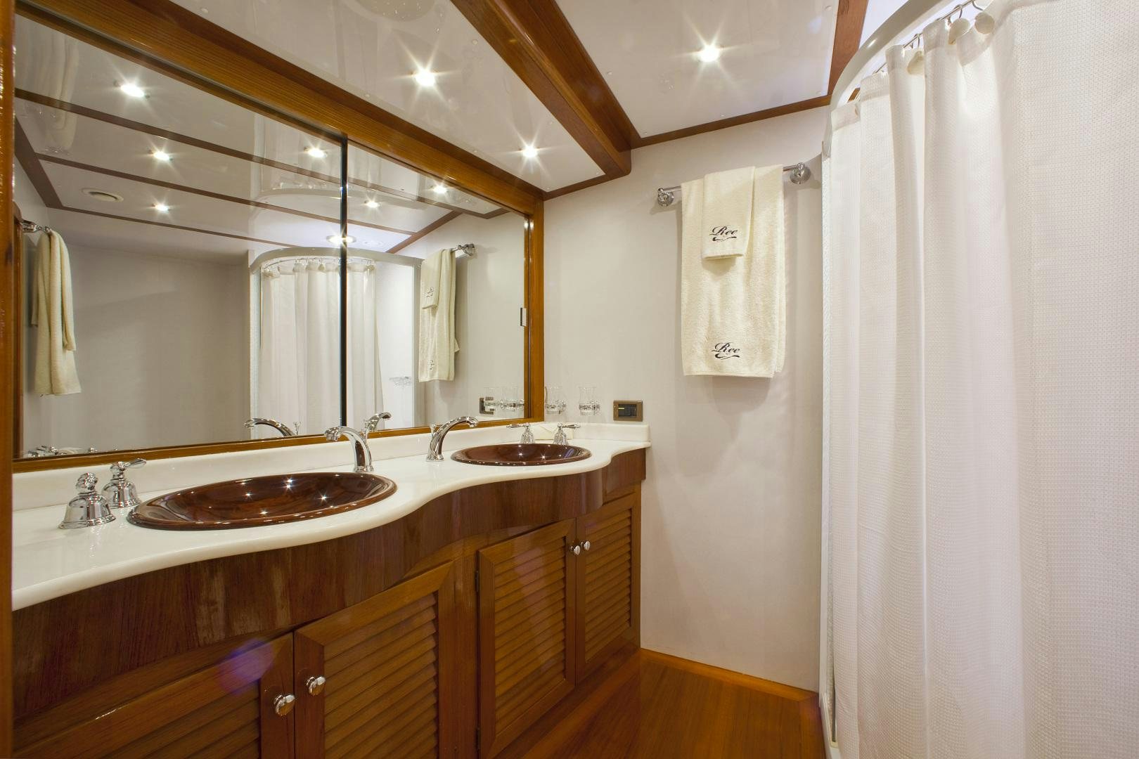 a bathroom with a large mirror aboard REE Yacht for Sale