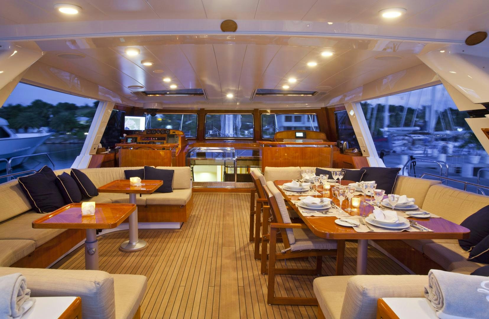 a restaurant with a large table and chairs aboard REE Yacht for Sale