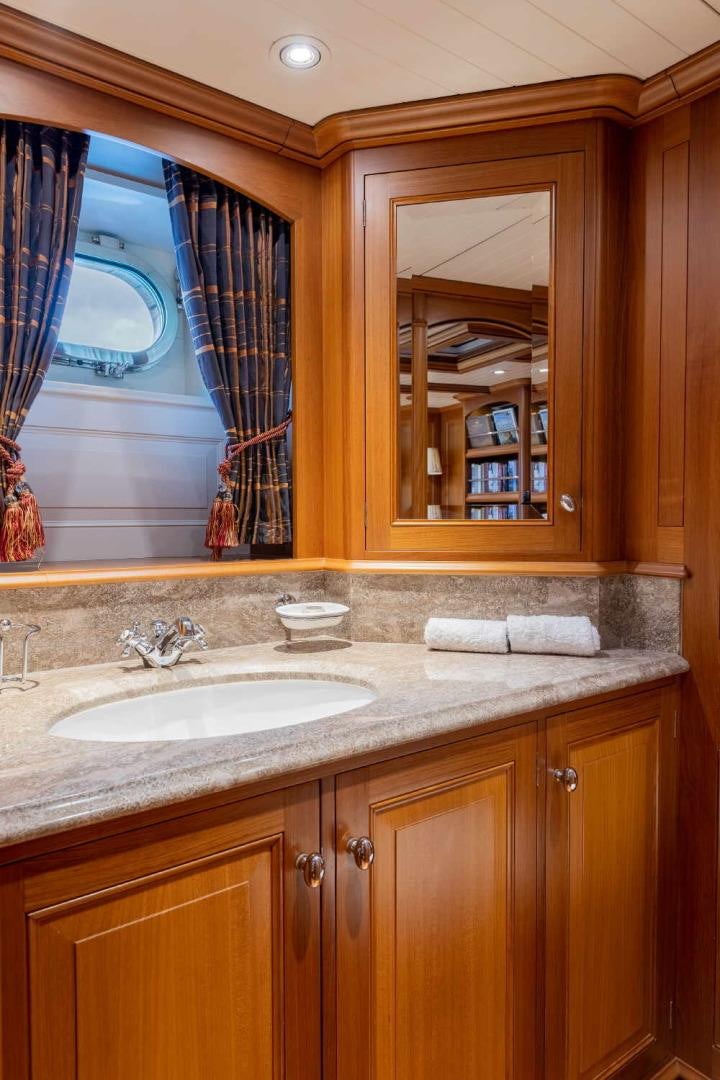 a bathroom with a sink and a mirror aboard BLUE TOO Yacht for Sale