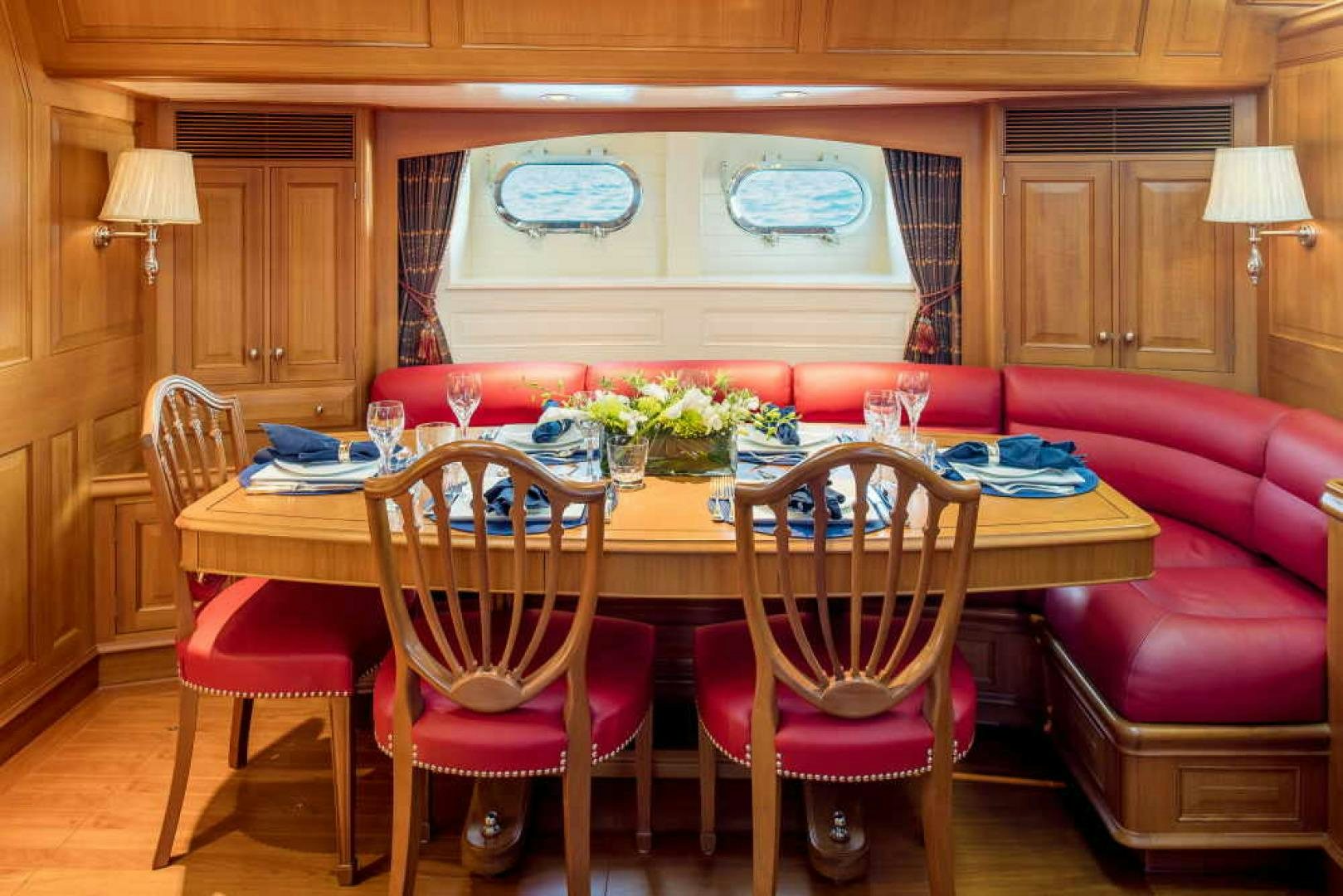 a dining table with chairs and a couch in the background aboard BLUE TOO Yacht for Sale