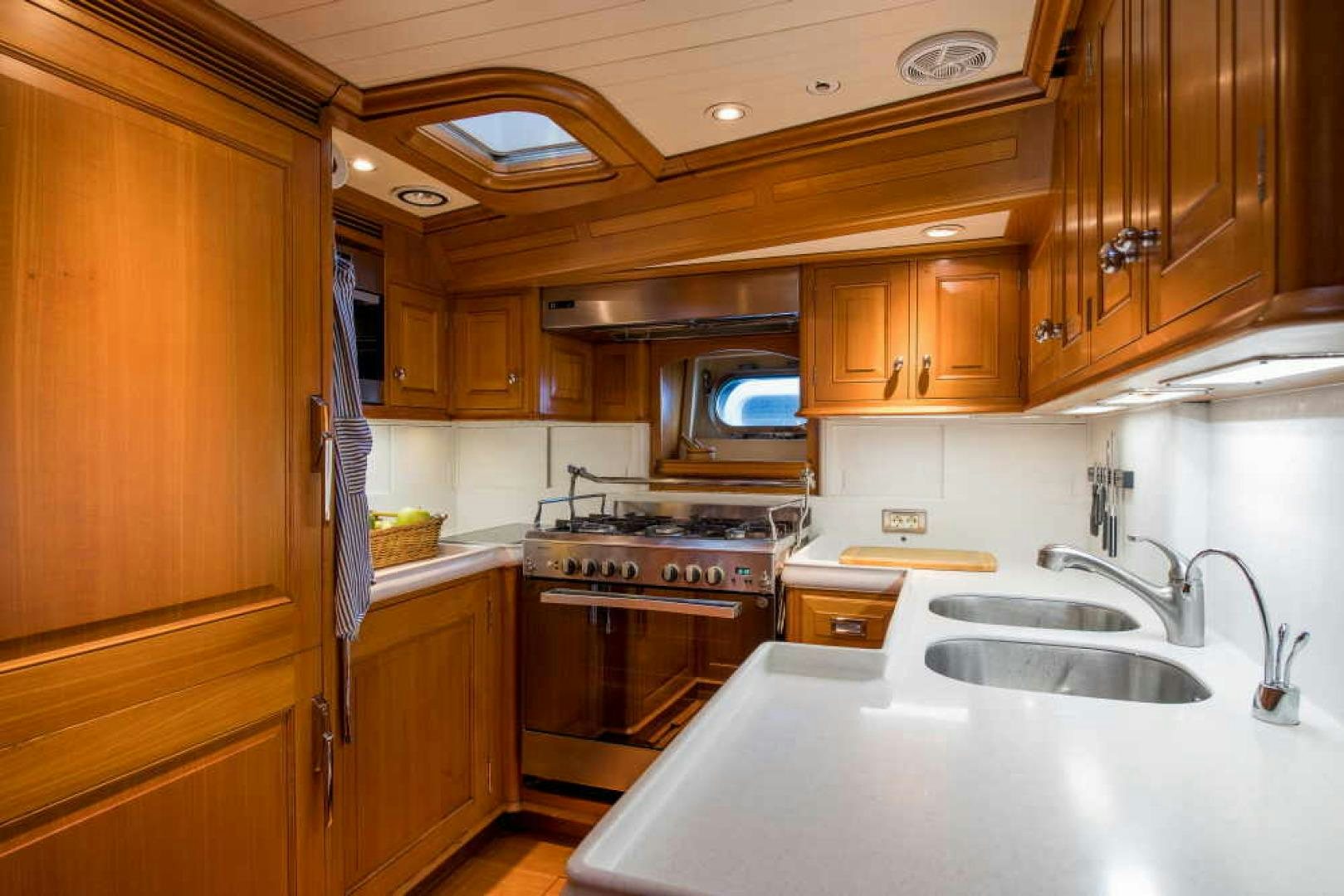 a kitchen with wooden cabinets aboard BLUE TOO Yacht for Sale