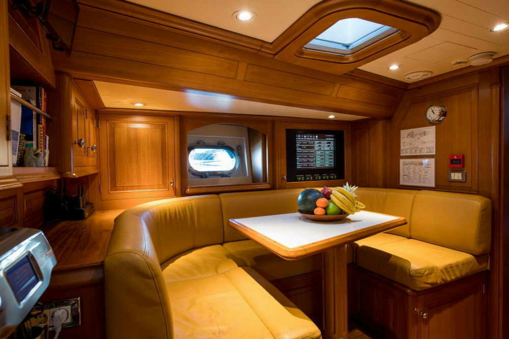 a room with a table and couches aboard BLUE TOO Yacht for Sale